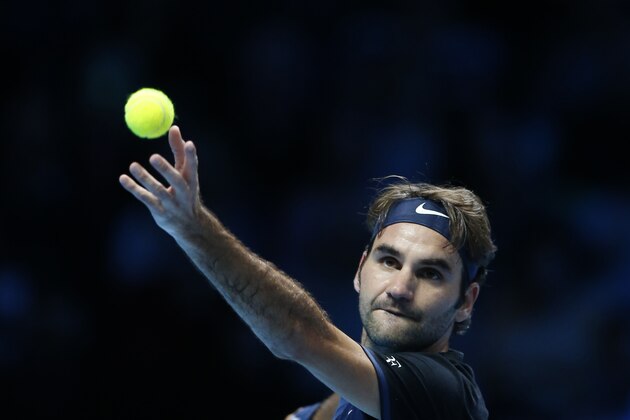 Roger Federer of Switzerland serves to Kei Nishikori of Japan during their singles tennis match at the ATP World Tour Finals at the O2 Arena in London, Thursday, Nov. 19, 2015. (AP Photo/Alastair Grant)