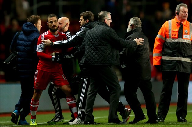 SOUTHAMPTON, ENGLAND - DECEMBER 04:  Mauricio Pochettino manager of Southampton holds back Pablo Daniel Osvaldo of Southampton after the Barclays Premier League match between Southampton and Aston Villa at St Mary's Stadium on December 4, 2013 in Southampton, England.  (Photo by Bryn Lennon/Getty Images)