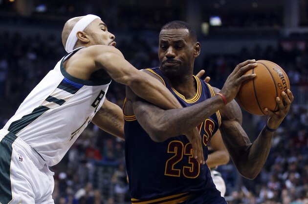 Cleveland Cavaliers' LeBron James is fouled by Milwaukee Bucks' Jerryd Bayless as he drives during the first half of an NBA basketball game Saturday, Nov. 14, 2015, in Milwaukee. (AP Photo/Morry Gash)