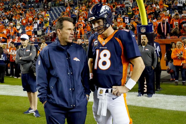 Denver Broncos quarterback Peyton Manning (18) talks with head coach Gary Kubiak prior to an NFL football game against the Green Bay Packers, Sunday, Nov. 1, 2015, in Denver. (AP Photo/Jack Dempsey)