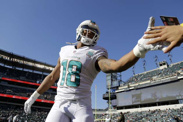 Miami Dolphins' Rishard Matthews greets a fan before an NFL football game against the Philadelphia Eagles, Sunday, Nov. 15, 2015, in Philadelphia. (AP Photo/Matt Rourke)