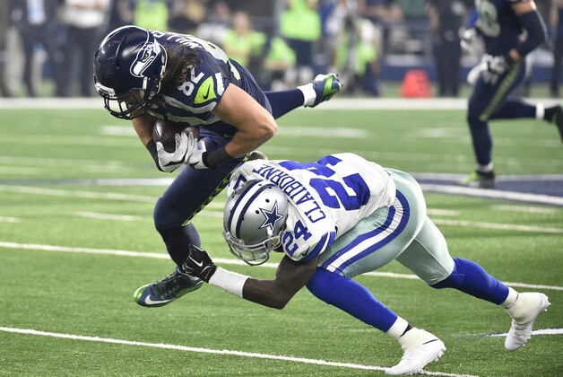 Seattle Seahawks tight end Luke Willson (82) is tackled by Dallas Cowboys cornerback Morris Claiborne (24) during a pass play in the first half of an NFL football game Sunday, Nov. 1, 2015, in Arlington, Texas. (AP Photo/Michael Ainsworth)