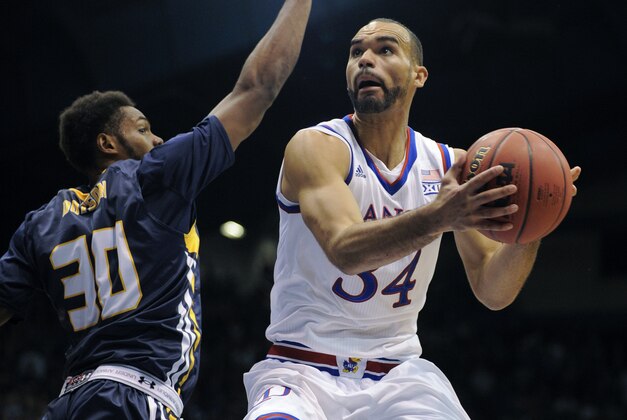 LAWRENCE, KS - NOVEMBER 13:  Perry Ellis #34 of the Kansas Jayhawks drives to the goal against Jon'te Dotson #30 of the Northern Colorado Bears in the first half at Allen Fieldhouse on November 13, 2015 in Lawrence, Kansas. (Photo by Ed Zurga/Getty Images)