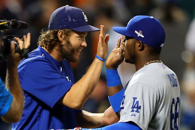 NEW YORK, NY - OCTOBER 13:  Clayton Kershaw #22 and Yasiel Puig #66 of the Los Angeles Dodgers celebrate after defeating the New York Mets in game four of the National League Division Series at Citi Field on October 13, 2015 in New York City.  The Dodgers defeated the Mets with a score of 3 to 1.  (Photo by Elsa/Getty Images)