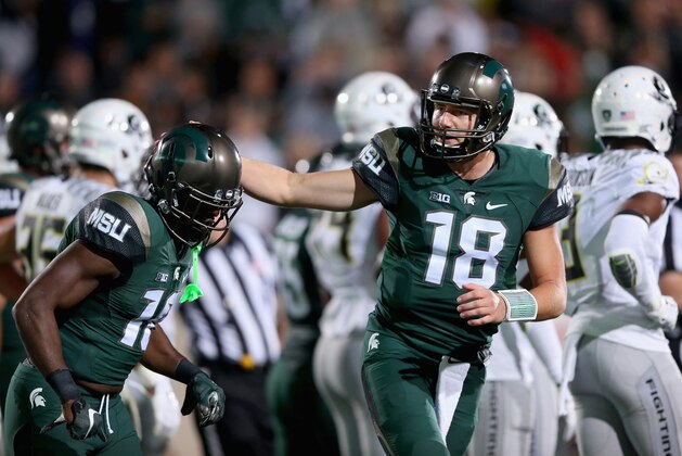 EAST LANSING, MI - SEPTEMBER 12:  Aaron Burbridge #16 of the Michigan State Spartans celebrates after scoring a touchdown with teammate Connor Cook #18 against the Oregon Ducks during their game at Spartan Stadium on September 12, 2015 in East Lansing, Michigan.  (Photo by Streeter Lecka/Getty Images)