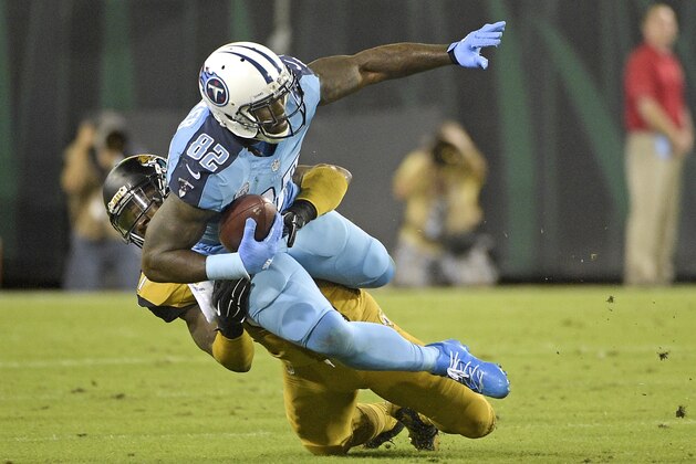 Tennessee Titans tight end Delanie Walker (82) is tackled by Jacksonville Jaguars strong safety Johnathan Cyprien after a short gain during the first half of an NFL football game in Jacksonville, Fla., Thursday, Nov. 19, 2015.(AP Photo/Phelan M. Ebenhack)