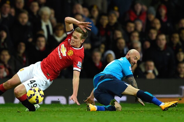 MANCHESTER, ENGLAND - DECEMBER 02:  James Wilson of Manchester United  is challenged by Stephen Ireland of Stoke City during the Barclays Premier League match between Manchester United and Stoke City at Old Trafford on December 2, 2014 in Manchester, England.  (Photo by Mike Hewitt/Getty Images)
