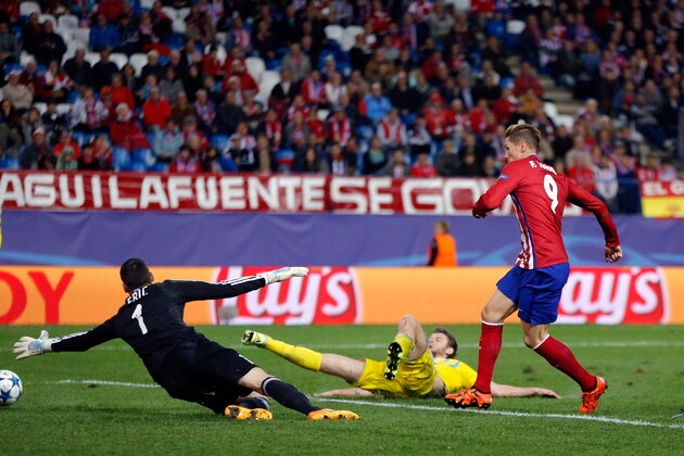 Astana's Denys Dedechko, center, scores an own goal under pressure from Atletico's Fernando Torres, right, during the Champions League group C soccer match between Atletico Madrid and Astana at the Vicente Calderon stadium in Madrid, Wednesday, Oct. 21, 2015.  (AP Photo/Daniel Ochoa de Olza)