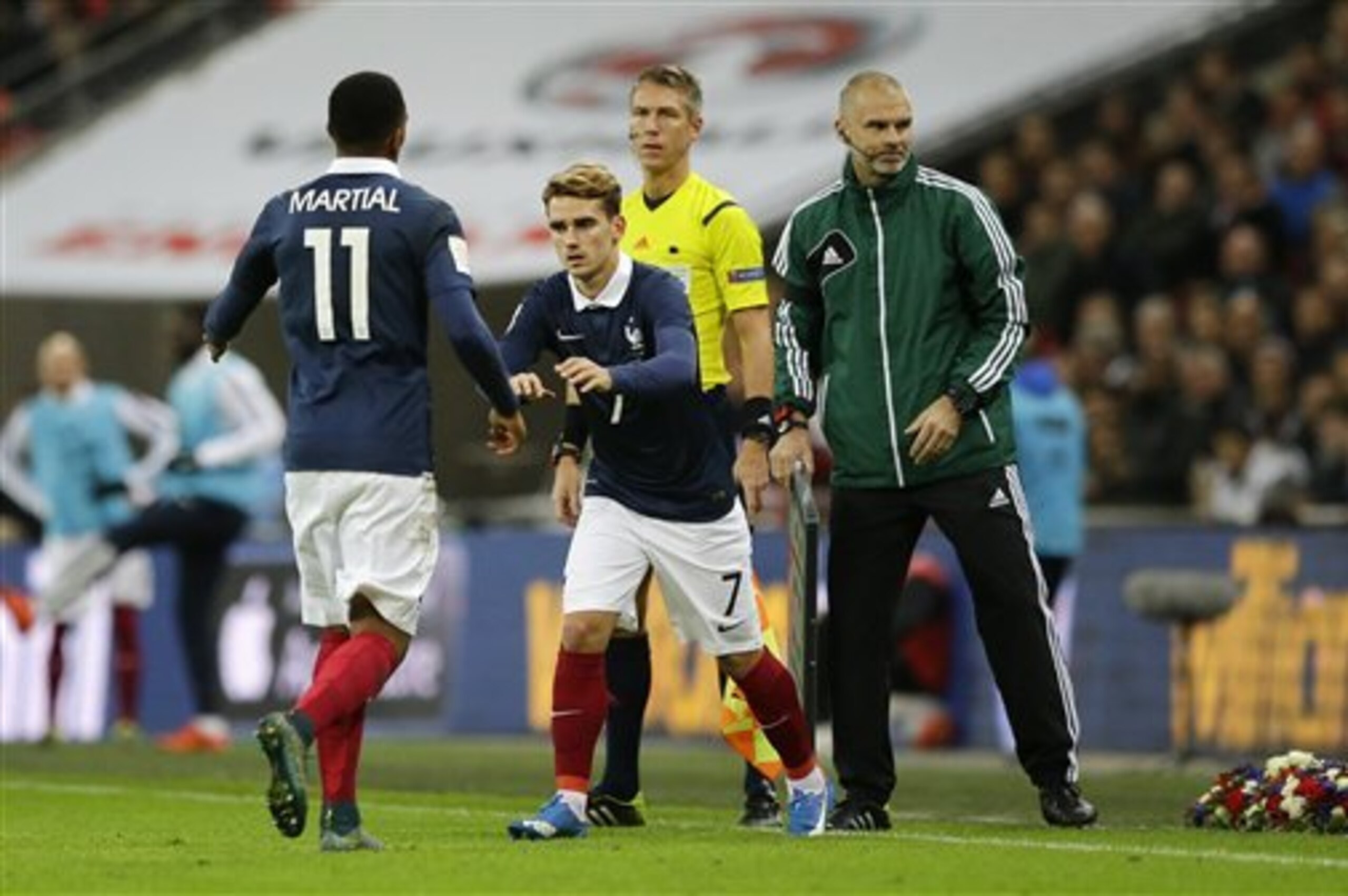 France's Antoine Griezmann replaces Anthony Martial during the international friendly soccer match between England and France at Wembley Stadium in London,  Tuesday, Nov. 17, 2015. France is playing England at Wembley on Tuesday after the countries decided the match should go ahead despite the deadly attacks in Paris last Friday night which killed scores of people. (AP Photo/Matt Dunham)