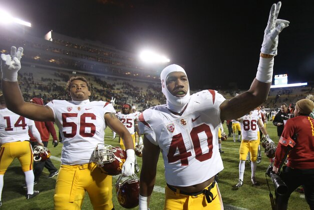 Nov 13, 2015; Boulder, CO, USA; USC Trojans linebacker Jabari Ruffin (40) and USC Trojans linebacker Anthony Sarao (56) celebrate after the game against the Colorado Buffaloes at Folsom Field. The Trojans won 27-24. Mandatory Credit: Chris Humphreys-USA TODAY Sports