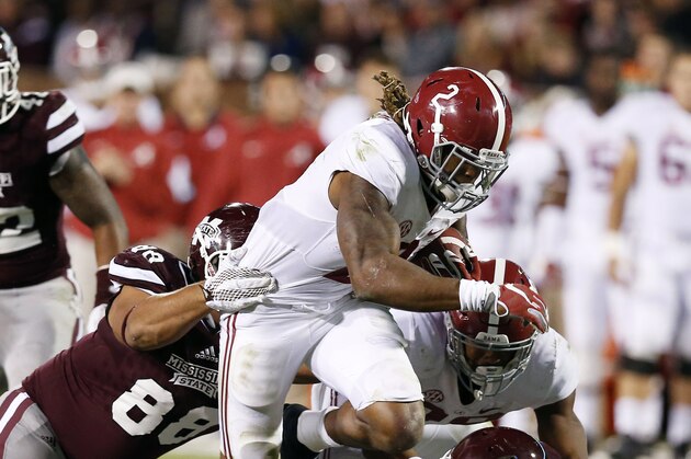 Alabama running back Derrick Henry (2) fights offs an attempted tackles by Mississippi State defensive back Kivon Coman (11) and defensive lineman Nick James (88) on his way to a short gain during the second half of an NCAA college football game in Starkville, Miss., Saturday, Nov. 14, 2015. No. 3 Alabama won 31-6. (AP Photo/Rogelio V. Solis)