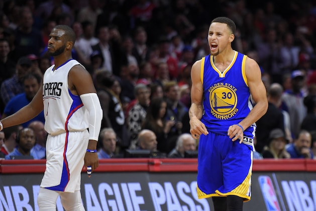 Golden State Warriors guard Stephen Curry, right, celebrates as Los Angeles Clippers guard Chris Paul walks by during the second half of an NBA basketball game, Thursday, Nov. 19, 2015, in Los Angeles.  The Warriors won 124-117. (AP Photo/Mark J. Terrill)