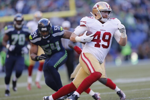 SEATTLE, WA - DECEMBER 14: Bruce Miller #49 of the San Francisco 49ers runs after making a reception during the game against the Seattle Seahawks at  CenturyLink Field on December 14, 2014 in Seattle, Washington. The Seahawks defeated the 49ers 17-7. (Photo by Michael Zagaris/San Francisco 49ers/Getty Images)