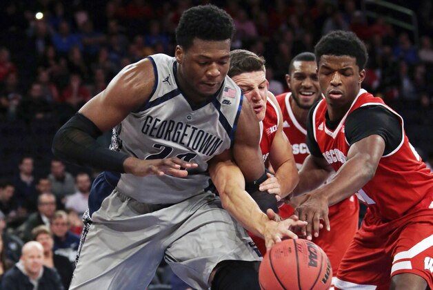 Georgetown forward Marcus Derrickson (24) battles for a loose ball with Wisconsin guard Zak Showalter and forward Khalil Iverson, right, during the first half of an NCAA college basketball game at Madison Square Garden on Friday, Nov. 20, 2015, in New York. (AP Photo/Adam Hunger)