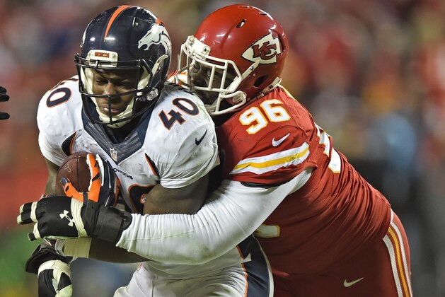KANSAS CITY, MO - NOVEMBER 30:  Defensive tackle Jaye Howard #96 of the Denver Broncos tackles running back Juwan Thompson #40 of the Kansas City Chiefs during the second half on November 30, 2014 at Arrowhead Stadium in Kansas City, Missouri.  (Photo by Peter G. Aiken/Getty Images)
