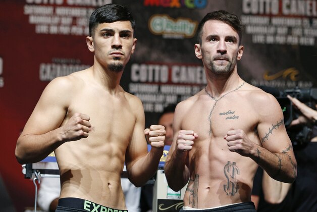 Lee Haskins, of England, right, and Randy Caballero pose for photographers during a weigh-in Friday, Nov. 20, 2015, in Las Vegas. The two are scheduled to fight in a IBF bantamweight title fight Saturday in Las Vegas. (AP Photo/John Locher)