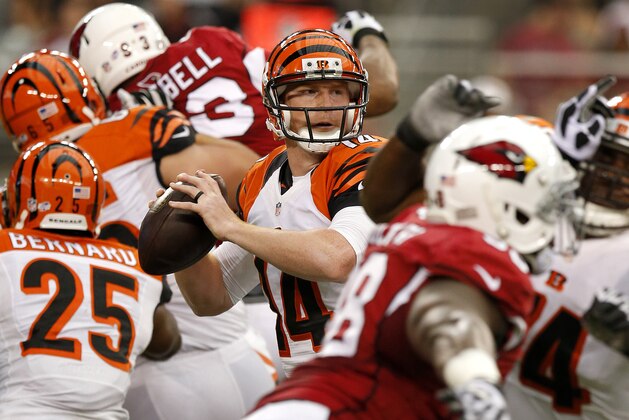 Cincinnati Bengals quarterback Andy Dalton (14) looks for a receiver against the Arizona Cardinals during the first half of an NFL preseason football game, Sunday, Aug. 24, 2014, in Glendale, Ariz. (AP Photo/Ross D. Franklin)