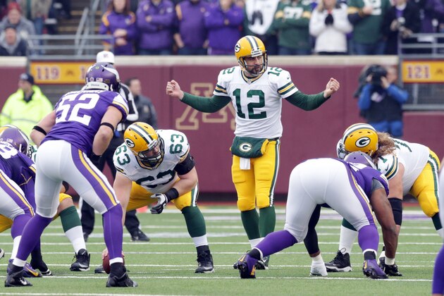 Green Bay Packers quarterback Aaron Rodgers directs his offense during the first half of an NFL football game against the Minnesota Vikings, Sunday, Nov. 23, 2014, in Minneapolis. (AP Photo/Jim Mone)