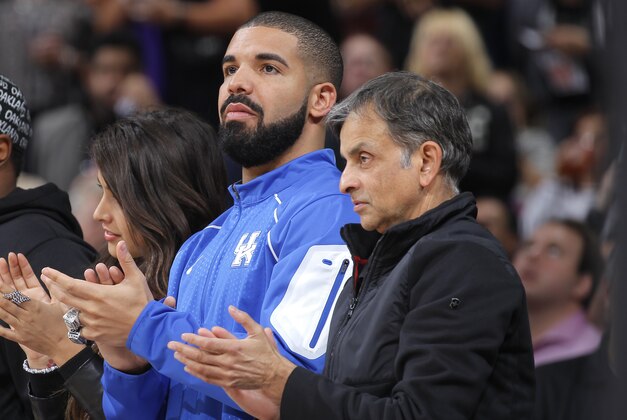 SACRAMENTO, CA - NOVEMBER 9: Anjali Ranadive, Canadian singer Drake and owner Vivek Ranadive of the Sacramento Kings watch the game between the San Antonio Spurs and Sacramento Kings on November 9, 2015 at Sleep Train Arena in Sacramento, California. NOTE TO USER: User expressly acknowledges and agrees that, by downloading and or using this photograph, User is consenting to the terms and conditions of the Getty Images Agreement. Mandatory Copyright Notice: Copyright 2015 NBAE (Photo by Rocky Widner/NBAE via Getty Images)