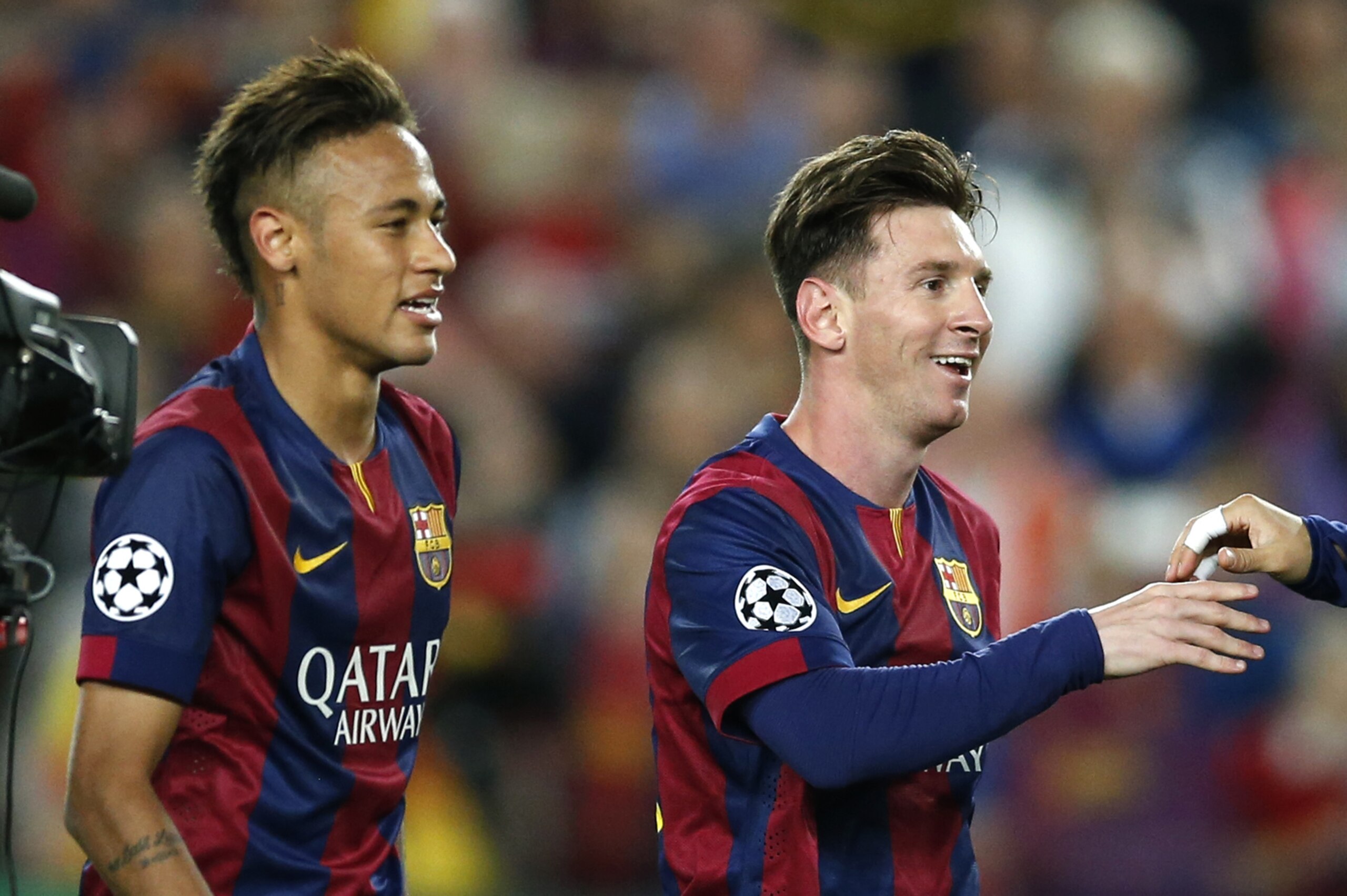 Barcelona's Neymar, left, and Lionel Messi celebrate after winning 3-0 in the Champions League semifinal first leg soccer match between Barcelona and Bayern Munich at the Camp Nou stadium in Barcelona, Spain, Wednesday, May 6, 2015.  (AP Photo/Manu Fernandez)