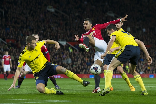 Manchester United's Memphis Depay, centre, attempts a shot past Middlesbrough's Daniel Ayala, right, and Ben Gibson during the English League Cup soccer match berween Manchester United and Middlesbrough at Old Trafford Stadium, Manchester, England, Wednesday Oct. 28, 2015. (AP Photo/Jon Super)