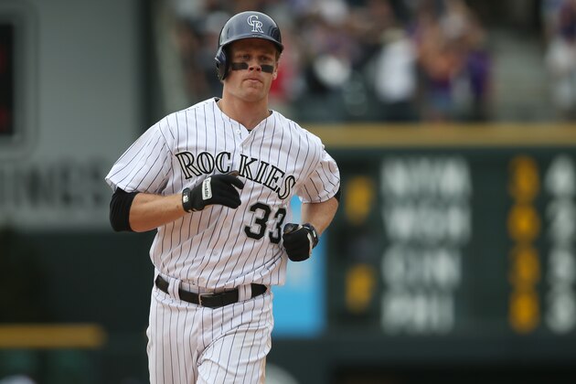 Colorado Rockies' Justin Morneau circles the bases after hitting a two-run, walkoff home run against the San Diego Padres in the 10th inning of the Rockies' 8-6 victory in 10 innings of a baseball game in Denver on Sunday, May 18, 2014. (AP Photo/David Zalubowski)
