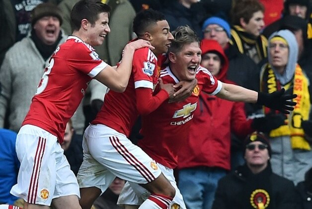 Manchester United's German midfielder Bastian Schweinsteiger (R) celebrates with Manchester United's Northern Irish midfielder Paddy McNair and Manchester United's English midfielder Jesse Lingard (2nd L) after his shot is deflected into the Watford net for United's second goal during the English Premier League football match between Watford and Manchester United at Vicarage Road Stadium in Watford, north of London on November 21, 2015. Manchester United won the game 2-1. AFP PHOTO / BEN STANSALL

RESTRICTED TO EDITORIAL USE. No use with unauthorized audio, video, data, fixture lists, club/league logos or 'live' services. Online in-match use limited to 75 images, no video emulation. No use in betting, games or single club/league/player publications.        (Photo credit should read BEN STANSALL/AFP/Getty Images)