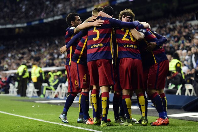 Barcelona's players celebrate a goal during the Spanish league 'Clasico' football match Real Madrid CF vs FC Barcelona at the Santiago Bernabeu stadium in Madrid on November 21, 2015. AFP PHOTO/ JAVIER SORIANO        (Photo credit should read JAVIER SORIANO/AFP/Getty Images)