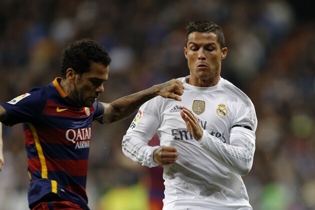Real Madrid's Cristiano Ronaldo fights for the ball with Barcelona's Dani Alves during the first clasico of the season between Real Madrid and Barcelona at the Santiago Bernabeu stadium in Madrid, Spain, Saturday, Nov. 21, 2015.  (AP Photo/Francisco Seco)