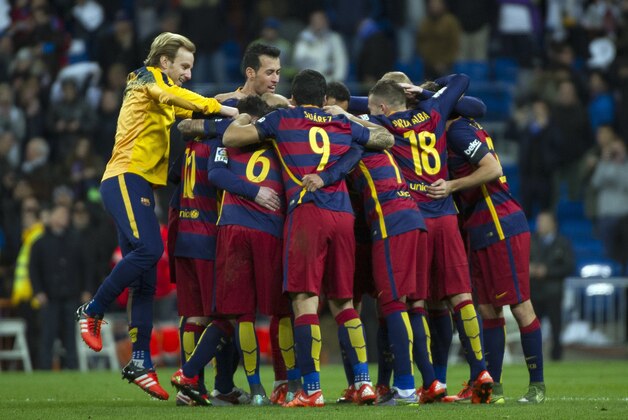Barcelona's players celebrate at the end of the Spanish league 'Clasico' football match Real Madrid CF vs FC Barcelona at the Santiago Bernabeu stadium in Madrid on November 21, 2014. AFP PHOTO / CURTO DE LA TORRE (Photo credit should read CURTO DE LA TORRE/AFP/Getty Images) Barcelona's players celebrate at the end of the Spanish league 'Clasico' football match Real Madrid CF vs FC Barcelona at the Santiago Bernabeu stadium in Madrid on November 21, 2014. AFP PHOTO / CURTO DE LA TORRE (Photo credit should read CURTO DE LA TORRE/AFP/Getty Images)