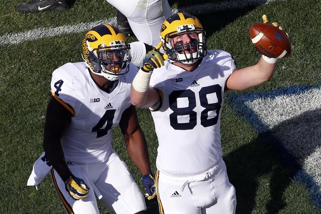 Michigan tight end Jake Butt (88) celebrates his touchdown catch with teammate De'Veon Smith (4) during the first half of an NCAA college football game against Penn State in State College, Pa., Saturday, Nov. 21, 2015. (AP Photo/Gene J. Puskar)