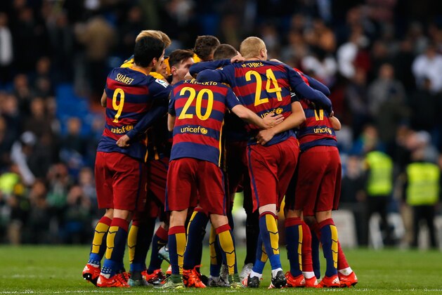 Barcelona players celebrate at the end of the first clasico of the season between Real Madrid and Barcelona at the Santiago Bernabeu stadium in Madrid, Spain, Saturday, Nov. 21, 2015. Barcelona won 4-0. (AP Photo/Daniel Ochoa de Olza)