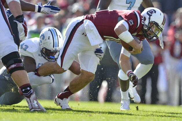 South Carolina quarterback Perry Orth is tackled by Citadel's Tevin Floyd on a quarterback keeper during the first half of an NCAA college football game Saturday, Nov. 21, 2015,  in Columbia,  S.C. (AP Photo/Richard Shiro)