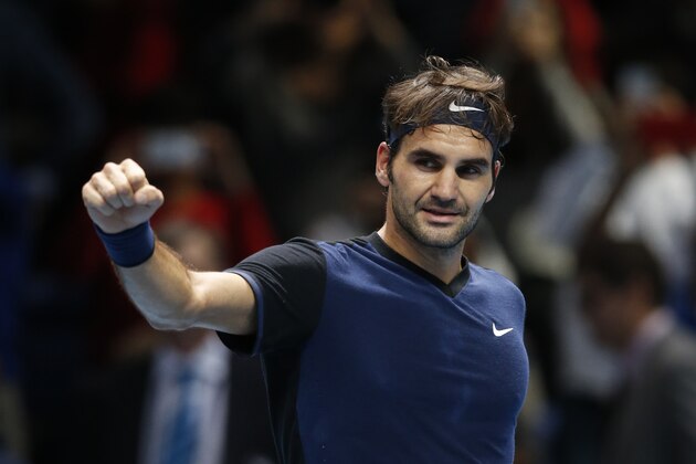 Roger Federer of Switzerland celebrates after defeating Kei Nishikori of Japan after their singles tennis match at the ATP World Tour Finals at the O2 Arena in London, Thursday, Nov. 19, 2015. (AP Photo/Alastair Grant)