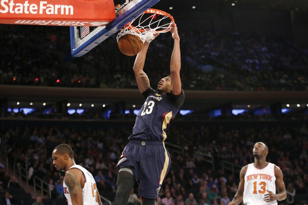 New Orleans Pelicans forward Anthony Davis (23) dunks with New York Knicks guard Jerian Grant (13) watching from the floor in the first half of an NBA basketball game at Madison Square Garden in New York, Sunday, Nov. 15, 2015. (AP Photo/Kathy Willens)