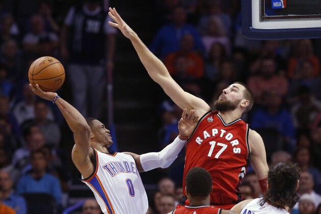 Oklahoma City Thunder guard Russell Westbrook (0) shoots as Toronto Raptors center Jonas Valanciunas (17) defends during the second quarter of an NBA basketball game in Oklahoma City, Wednesday, Nov. 4, 2015. (AP Photo/Sue Ogrocki)