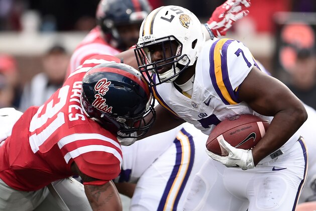 OXFORD, MS - NOVEMBER 21:  Leonard Fournette #7 of the LSU Tigers is hit by DeMarquis Gates #31 of the Mississippi Rebels during the first quarter of a game at Vaught-Hemingway Stadium on November 21, 2015 in Oxford, Mississippi.  (Photo by Stacy Revere/Getty Images)