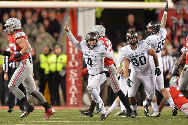 COLUMBUS, OH - NOVEMBER 21:  Michael Geiger #4 of the Michigan State Spartans celebrates after kicking a 41-yard field goal as time expired against the Ohio State Buckeyes at Ohio Stadium on November 21, 2015 in Columbus, Ohio. Michigan State defeated Ohio State 17-14.  (Photo by Jamie Sabau/Getty Images)