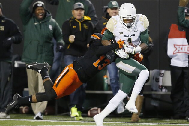 Baylor wide receiver Corey Coleman (1) is tackled by Oklahoma State safety Jordan Sterns (13) in the first quarter of an NCAA college football game in Stillwater, Okla., Saturday, Nov. 21, 2015. (AP Photo/Sue Ogrocki)