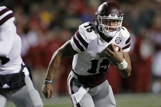 Mississippi State's Dak Prescott (15) keep the ball and runs during the the first half of an NCAA college football game against Arkansas, Saturday, Nov. 21, 2015 in Fayetteville, Ark. (AP Photo/Samantha Baker)