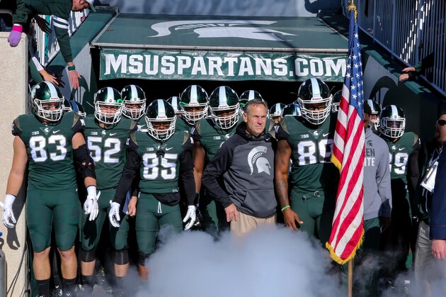 EAST LANSING, MI - NOVEMBER 14: Head coach Mark Dantonio of the Michigan State Spartans leads his team out of the tunnel prior to the game against the Maryland Terrapins at Spartan Stadium  on November 14, 2015 in East Lansing, Michigan. (Photo by Rey Del Rio/Getty Images)