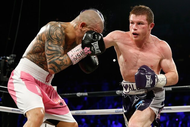 LAS VEGAS, NV - NOVEMBER 21:  (R-L) Canelo Alvarez throws a right at Miguel Cotto during their middleweight fight at the Mandalay Bay Events Center on November 21, 2015 in Las Vegas, Nevada.  (Photo by Isaac Brekken/Getty Images)