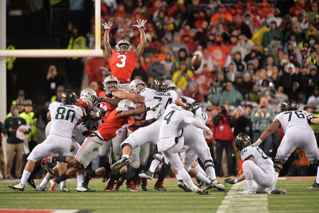 COLUMBUS, OH - NOVEMBER 21:  Michael Thomas #3 of the Ohio State Buckeyes goes high to attempt to block a 41-yard field goal attempt by Michael Geiger #4 of the Michigan State Spartans as time expires at Ohio Stadium on November 21, 2015 in Columbus, Ohio. The kick was good and Michigan State defeated Ohio State 17-14.  (Photo by Jamie Sabau/Getty Images)