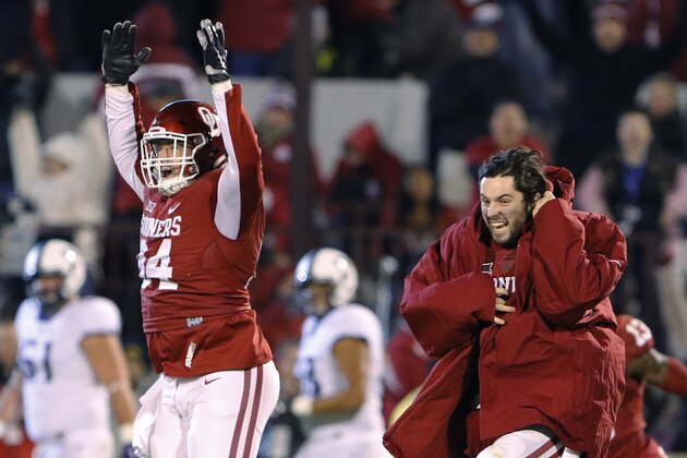 Oklahoma cornerback Marcus Green, left, and quarterback Baker Mayfield, right, celebrate after Oklahoma defeated TCU in an NCAA college football game in Norman, Okla., Saturday, Nov. 21, 2015. (AP Photo/Alonzo Adams)