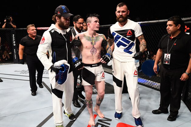 MONTERREY, MEXICO - NOVEMBER 21:  Scott Jorgensen of the United States is helped out of the Octagon after suffering an injury against Alejandro Perez of Mexico in their bantamweight bout during the UFC Fight Night event at Arena Monterrey on November 21, 2015 in Monterrey, Mexico.  (Photo by Jeff Bottari/Zuffa LLC/Zuffa LLC via Getty Images)