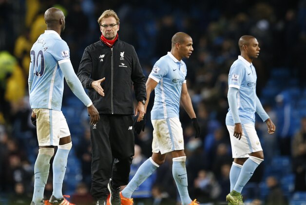 Liverpool's manager Jurgen Klopp, second left goes to shake hands with Manchester City's Eliaquim Mangalaafter the end of the English Premier League soccer match between Manchester City and Liverpool at the Etihad Stadium, Manchester, England, Saturday, Nov. 21, 2015. (AP Photo/Jon Super)
