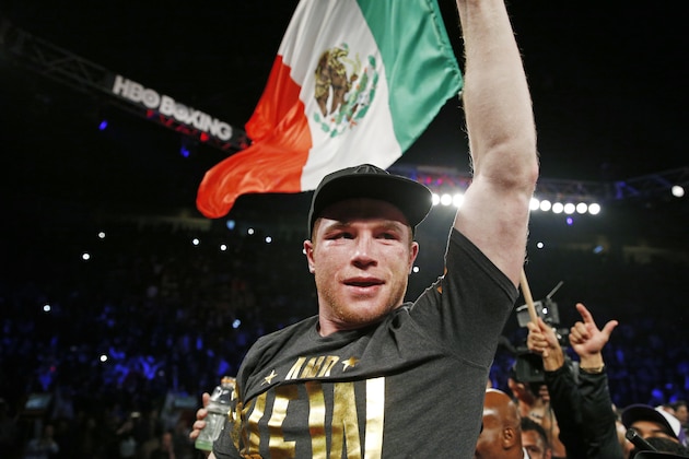 Canelo Alvarez, of Mexico, celebrates  his win over Miguel Cotto, of Puerto Rico,during a WBC middleweight title bout Saturday, Nov. 21, 2015, in Las Vegas. (AP Photo/John Locher)