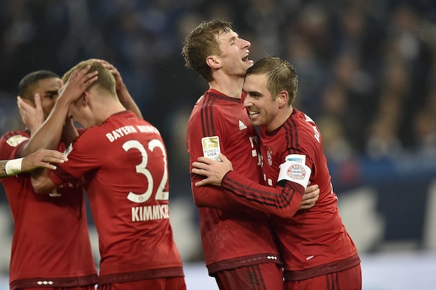 Bayern's Thomas Mueller, center, celebrates his goal with Bayern's Philipp Lahm, right, during the German Bundesliga soccer match between FC Schalke 04 and Bayern Munich in Gelsenkirchen, Germany, Saturday, Nov. 21, 2015. Schalke was defeated by Bayern with 1-3. (AP Photo/Martin Meissner)