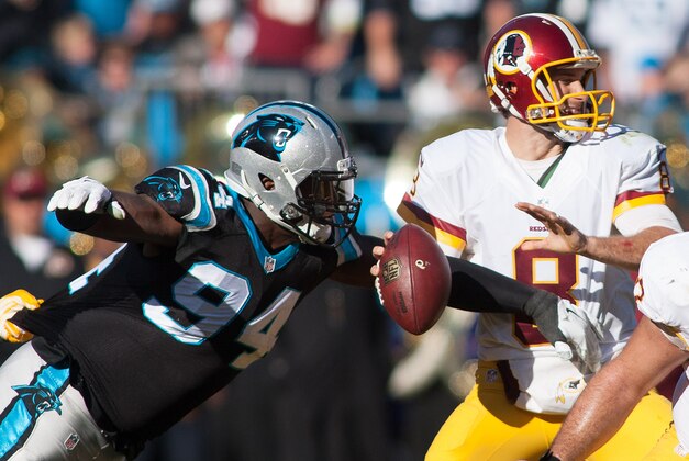 Nov 22, 2015; Charlotte, NC, USA; Washington Redskins quarterback Kirk Cousins (8) attempts the throw the ball as Carolina Panthers defensive end Kony Ealy (94) tackles during the second quarter at Bank of America Stadium. Mandatory Credit: Jeremy Brevard-USA TODAY Sports