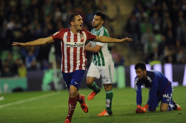 Atletico Madrid's midfielder Koke (L) celebrates after scoring a goal during the Spanish league football match Real Betis Balompie vs Club Atletico de Madrid at the Benito Villamarin stadium in Sevilla on November 22, 2015.  AFP PHOTO / CRISTINA QUICLER        (Photo credit should read CRISTINA QUICLER/AFP/Getty Images)